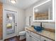 Bathroom with blue vessel sink and a door to backyard at 8415 Colony Barn Rd, Clermont, FL 34714