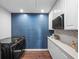 Laundry room with modern washer and dryer, and a blue accent wall at 8415 Colony Barn Rd, Clermont, FL 34714