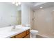 Clean bathroom with a shower, toilet, and wood vanity at 9001 Village Green Blvd, Clermont, FL 34711