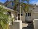 Front entrance of a house with a light-colored exterior and landscaping at 9001 Village Green Blvd, Clermont, FL 34711