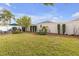 Landscaped backyard with patio furniture and lush lawn at 906 Drakeswood Ave, The Villages, FL 32162