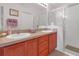 Bathroom with double vanity and walk-in shower at 906 Drakeswood Ave, The Villages, FL 32162