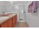Double vanity bathroom with a walk-in shower and updated fixtures at 906 Drakeswood Ave, The Villages, FL 32162