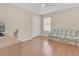 Bedroom with wood floors and sofa at 906 Drakeswood Ave, The Villages, FL 32162