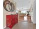 Bright and airy entryway with red Asian-style cabinet and view of living room at 906 Drakeswood Ave, The Villages, FL 32162