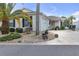 Side view of a single-story house with palm trees and well-manicured landscaping at 906 Drakeswood Ave, The Villages, FL 32162