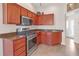 Kitchen with stainless steel appliances and granite countertops at 906 Drakeswood Ave, The Villages, FL 32162