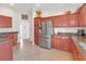 Spacious kitchen featuring stainless steel appliances and granite countertops at 906 Drakeswood Ave, The Villages, FL 32162