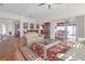 Bright and airy living area with hardwood floors, comfortable seating and large windows at 906 Drakeswood Ave, The Villages, FL 32162