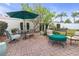 Outdoor patio with seating area, umbrella, and fire pit at 906 Drakeswood Ave, The Villages, FL 32162