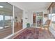 Relaxing screened porch with wicker furniture and view of backyard at 906 Drakeswood Ave, The Villages, FL 32162