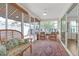 Bright and airy sunroom with wicker furniture, views of the backyard at 906 Drakeswood Ave, The Villages, FL 32162