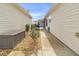 Landscaped side yard with a gravel pathway and storage bin at 906 Drakeswood Ave, The Villages, FL 32162