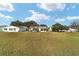 Spacious backyard with grassy area at 934 Orchid St, The Villages, FL 32159