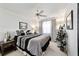 Bedroom with king-size bed, ceiling fan, and large mirror at 934 Orchid St, The Villages, FL 32159