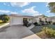 Charming yellow house with a neatly landscaped front yard at 934 Orchid St, The Villages, FL 32159