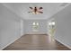 Spacious bedroom featuring wood-look floors and access to patio at 979 Princeton Dr, Clermont, FL 34711
