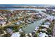 Aerial view of waterfront property with boat slips and lush landscaping at 100 Via Capri, New Smyrna Beach, FL 32169