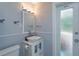 Small bathroom with white vanity and frosted glass door at 100 Via Capri, New Smyrna Beach, FL 32169