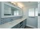 Modern bathroom with double vanity and gray cabinets at 100 Via Capri, New Smyrna Beach, FL 32169