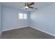 Bright bedroom with gray carpet and ceiling fan at 100 Via Capri, New Smyrna Beach, FL 32169