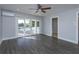 Bedroom with pool view, sliding doors, and ceiling fan at 100 Via Capri, New Smyrna Beach, FL 32169