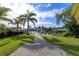 Landscaped backyard walkway offering scenic views of the canal at 100 Via Capri, New Smyrna Beach, FL 32169