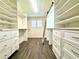 Spacious walk-in closet featuring custom shelving and storage with a ladder at 100 Via Capri, New Smyrna Beach, FL 32169