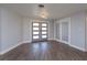 Bright entryway with gray double doors and gray vinyl plank flooring at 100 Via Capri, New Smyrna Beach, FL 32169