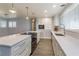 White kitchen with island, stainless steel appliances, and quartz countertops at 100 Via Capri, New Smyrna Beach, FL 32169