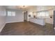 Bright kitchen featuring white cabinets, an island, and new flooring at 100 Via Capri, New Smyrna Beach, FL 32169