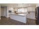 Modern kitchen with white cabinets, island, and stainless steel appliances at 100 Via Capri, New Smyrna Beach, FL 32169