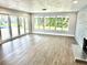 Bright living room with large windows, sliding door, and fireplace view of pool at 100 Via Capri, New Smyrna Beach, FL 32169