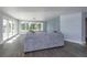 Living room with gray sectional sofa and sliding glass doors at 100 Via Capri, New Smyrna Beach, FL 32169