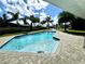 Sparkling blue pool surrounded by lush tropical landscaping, perfect for outdoor living at 100 Via Capri, New Smyrna Beach, FL 32169