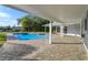 Covered patio overlooking the refreshing blue swimming pool at 100 Via Capri, New Smyrna Beach, FL 32169