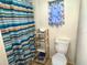 Bathroom with shower, toilet and shelving unit at 1005 Oakland St. St, Tavares, FL 32778