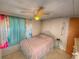 Bright bedroom with a metal bed frame and window at 1005 Oakland St. St, Tavares, FL 32778