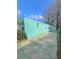 Side view of a teal mobile home showcasing its length and yard space at 1005 Oakland St. St, Tavares, FL 32778