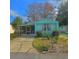 Quaint teal mobile home with mature trees and a spacious yard at 1005 Oakland St. St, Tavares, FL 32778