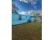 Backyard view of teal mobile home with storage shed at 1005 Oakland St. St, Tavares, FL 32778