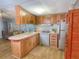 Efficient kitchen with wood cabinets and modern appliances at 1005 Oakland St. St, Tavares, FL 32778