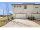 Attached garage with concrete driveway and landscaping at 10093 Pearson Ave, Orlando, FL 32827