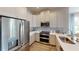 Modern kitchen with stainless steel appliances and white cabinetry at 10093 Pearson Ave, Orlando, FL 32827