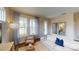 Living room with beige sofa, armchair, and large windows at 10093 Pearson Ave, Orlando, FL 32827