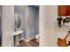 Small powder room with pedestal sink and decorative wall art at 10093 Pearson Ave, Orlando, FL 32827