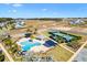 Community pool and tennis courts are seen from above at 1107 Sugar Loaf Key Loop, Lady Lake, FL 32159