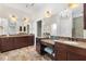 Elegant bathroom boasts double vanity and granite countertops at 1107 Sugar Loaf Key Loop, Lady Lake, FL 32159