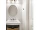 Small bathroom with round mirror and pedestal sink at 1107 Sugar Loaf Key Loop, Lady Lake, FL 32159