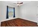 Bedroom with hardwood floors and window with blinds at 1107 Sugar Loaf Key Loop, Lady Lake, FL 32159